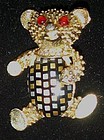 Vintage teddy bear pin with celluloid plaid belly