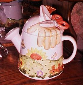 Large ceramic watering can and gardening themed cookie jar