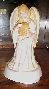 Musical Angel hugging little girl figurine plays "Jesus loves me"