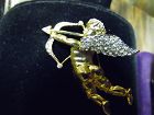 Gold Tone Cupid pin with Rhinestone wings and bow