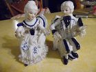 Victorian pair seated figurines cobalt blue and white net lace trim