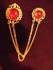 Gold tone sweater guard pins with ruby red cabochons