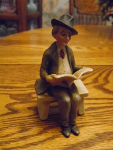 Homco style bisque figurine of man reading paper on a park bench