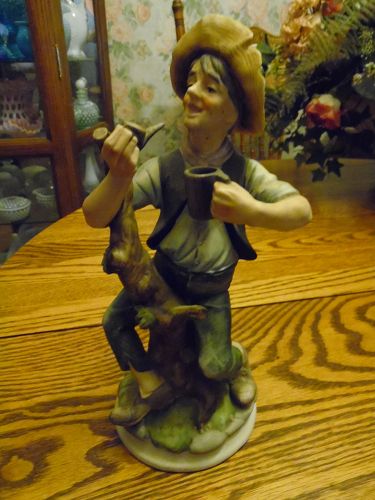 Homco style bisque figurine of man and a tree stump smoking pipe