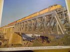 Union Pacific Diesel power freight crosses bridge color print late 50s