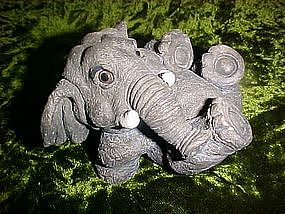 Frolicking elephant figurine with glass eyes