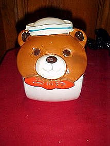 Tilted ceramic cookie jar with sailor bear face
