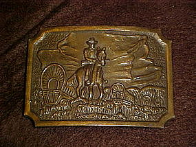 Cowboy and wagon train, brass belt buckle