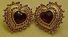 Goldtone heart earrings with ruby red rhinestone center