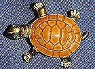 Adorable gold tone turtle pin with rhinestone eyes
