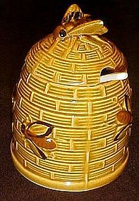 Vintage beehive with bees, ceramic honey jar