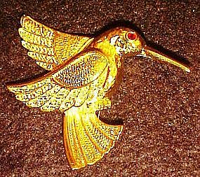 Gold tone hummingbird pin, rhinestone eye