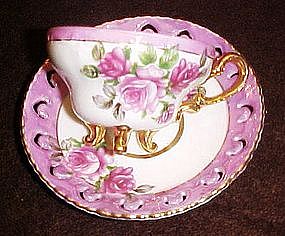 Fancy demitasse cup and saucer, lustre,three legs