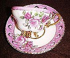 Fancy demitasse cup and saucer, lustre,three legs