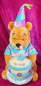 Winnie the Pooh plush, with musical Happy Birthday cake