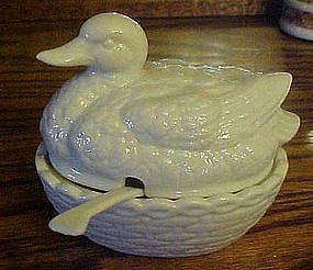 Porcelain duck on a nest sauce dish with spoon