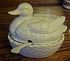 Porcelain duck on a nest sauce dish with spoon