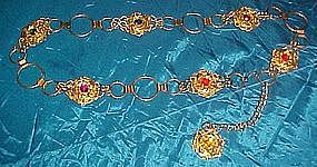 Goldtone metal filigree belt with faux rhinestones