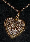 Two tone filigree heart locket , Avon