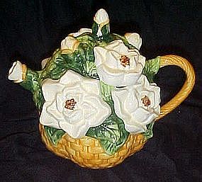 Basket of white cammilia's or rose's, ceramic teapot