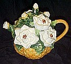 Basket of white cammilia's or rose's, ceramic teapot