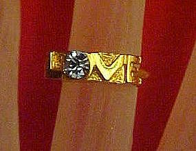 Gold tone LOVE ring with blue topaz birthstone