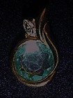 KJL goldtone pendant with aqua blue rhinestone center