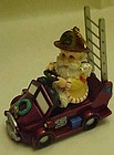 Fireman santa ornament driving fire truck
