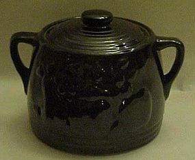 Old black glaze bean pot with fruit