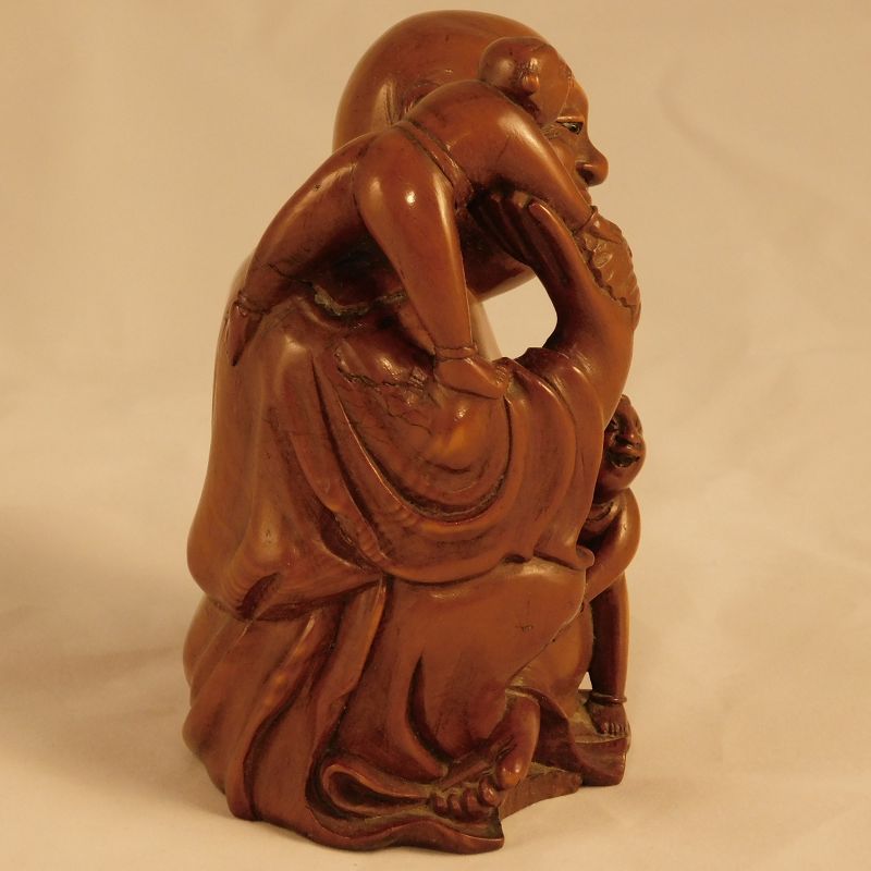 A Good Chinese Boxwood Carving of Budai, with Bat and Children