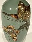 Signed Meiji pd cloisonné vase. Polychrome butterflies on green ground