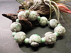 Strands of large carved Chinese motif jadeite beads