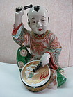 Famille rose -enameled porcelain statue  of a boy