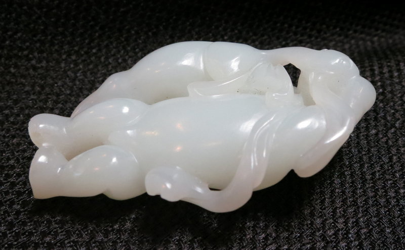 A nephrite white jade boy with a badger toggle Hetian