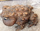 A carved wooden frog