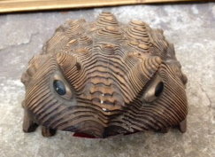 A carved wooden frog