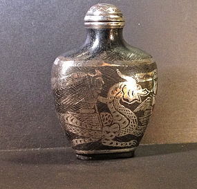Silver inlay snuff bottle with warrior ridding a dragon