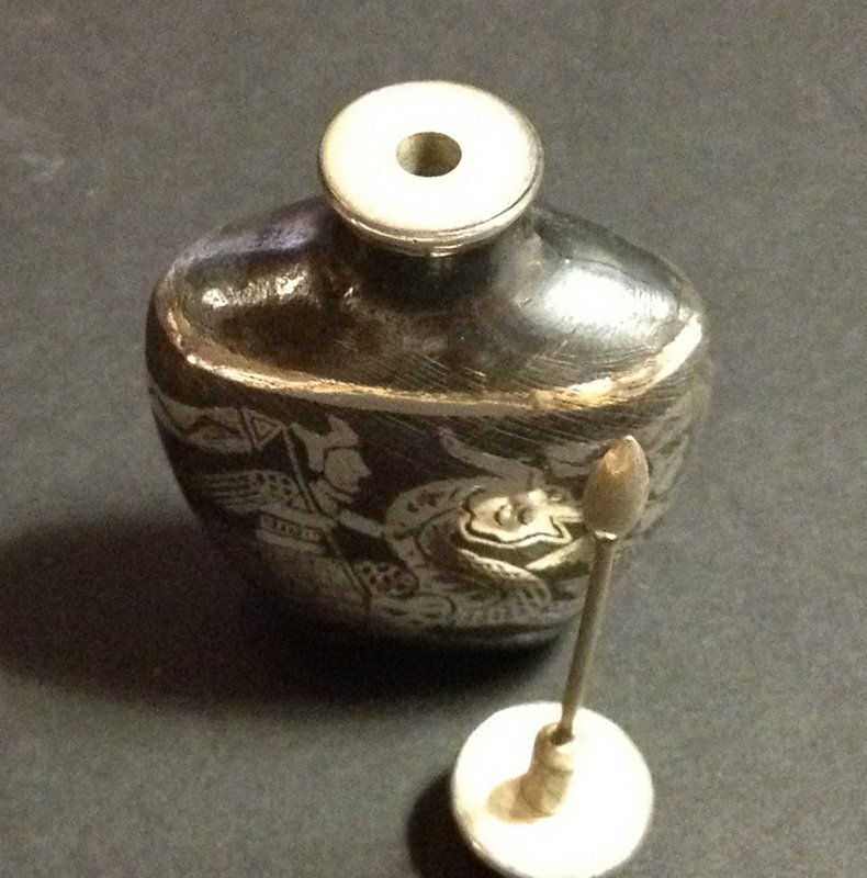 Silver inlay snuff bottle with warrior ridding a dragon