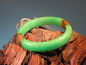 Jade bangle with 14 K gold fitting