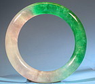 CARVED JADEITE BANGLE.