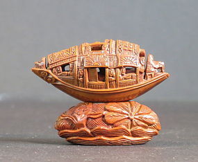 Carved olive pit 'Pleasure boat'