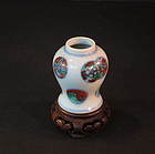 Miniture antique Chinese porcelain jar with carved base