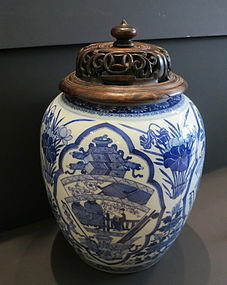 A Chinese blue and white porcelain jar with carved lid
