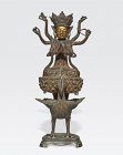 A cast bronze Buddhist or Taoist figure on a peacock