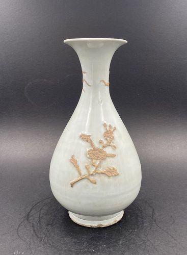 A Ming Dynasty White Glazed Pear Shaped Vase with Flowers in Biscuit.