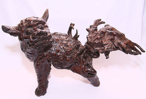 China. Root carving. Old snarling qilin.