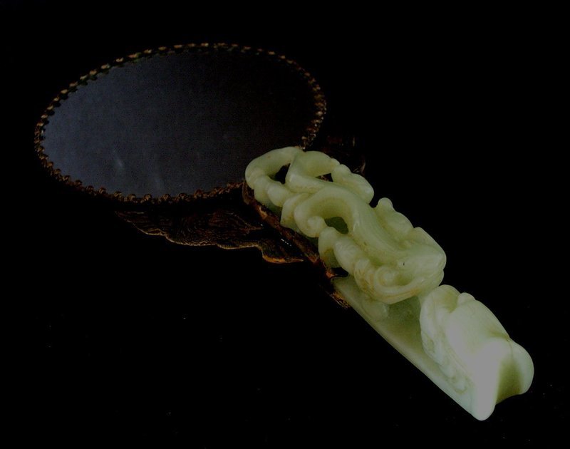 Chinese jade belt hook on a mirror